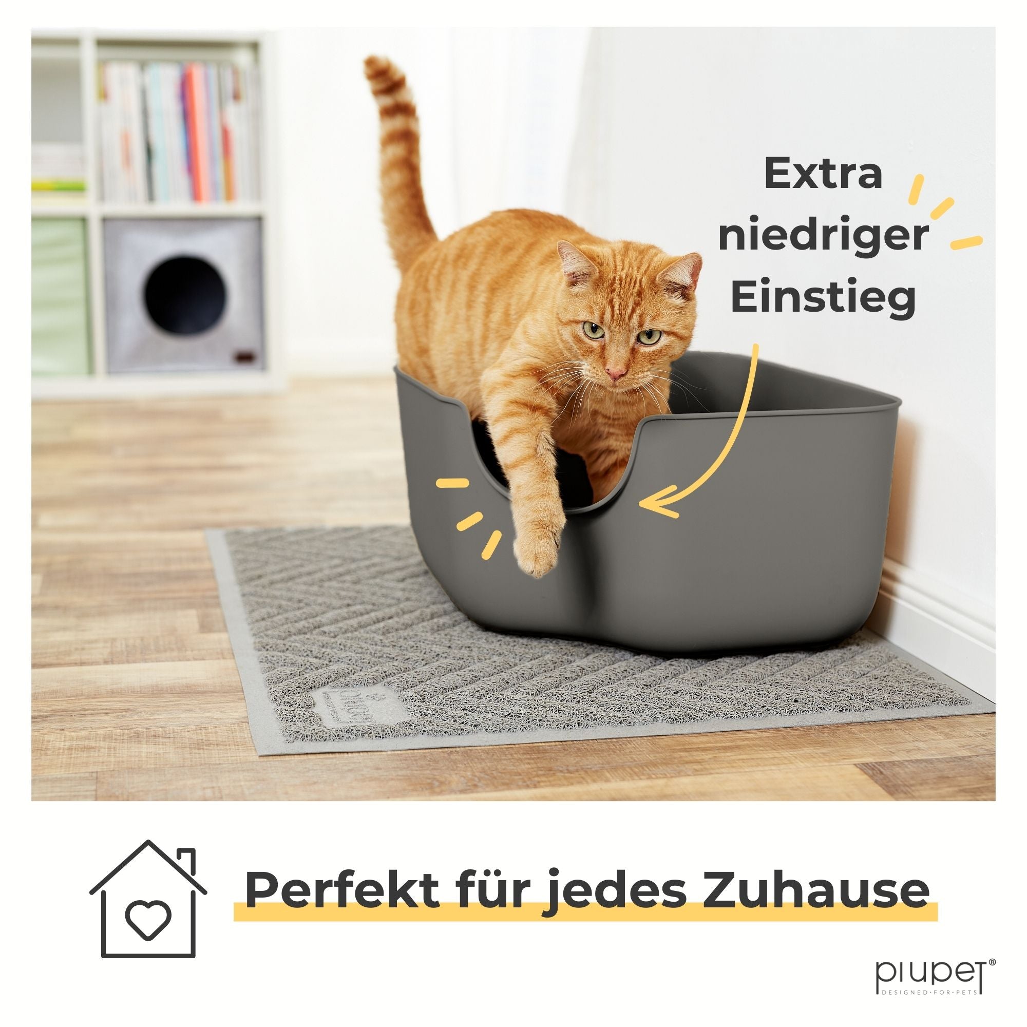 Orangefarbene Katze steigt durch den extra niedrigen Einstieg aus der Katzentoilette. Text: Extra niedriger Einstieg – Perfekt für jedes Zuhause.